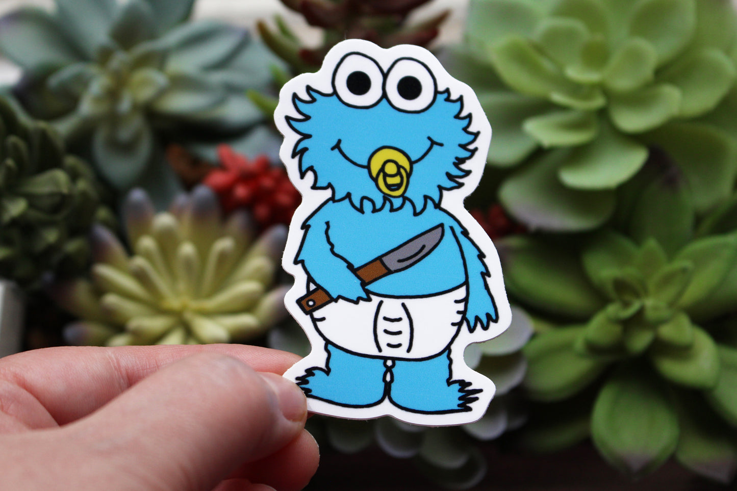 Baby cookie monster wearing a diaper holding a knife sucking a pacifier horror parody sticker by SpookyKillerBabies.com