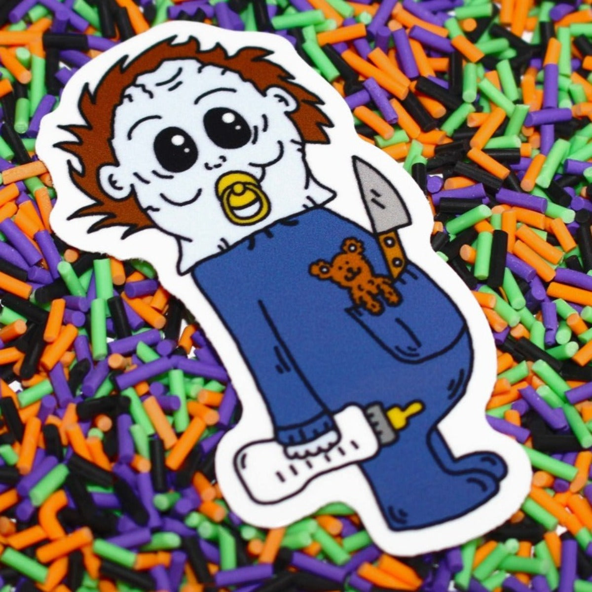Baby Michael Myers Sticker by SpookyKillerBabies.com Holding his Baby Bottle, Teddy Bear and Knife. 