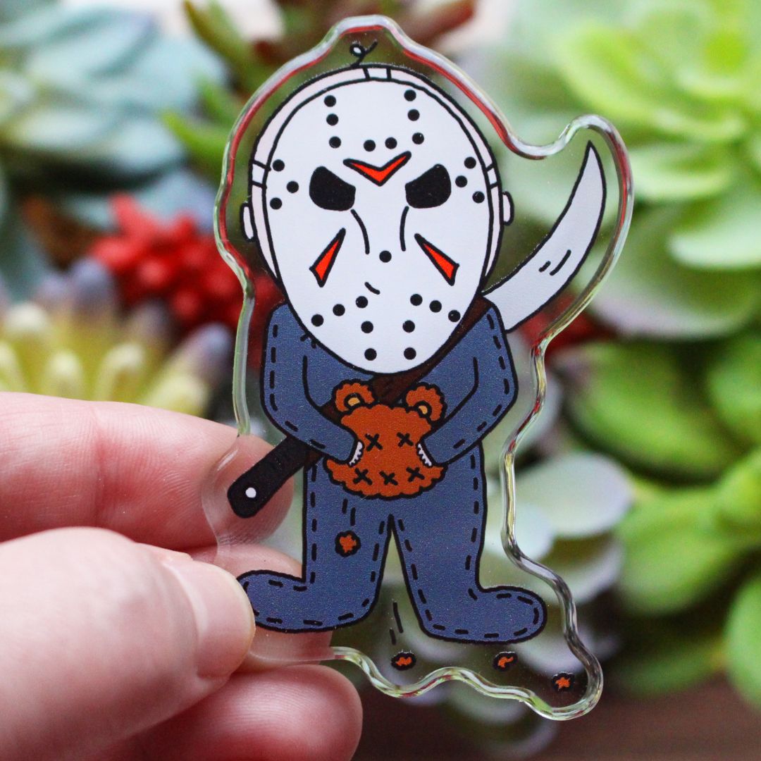 Baby Jason Voorhees with his sword and cut teddy bear head magnet. Spooky Horror Parody by SpookyKillerBabies.com